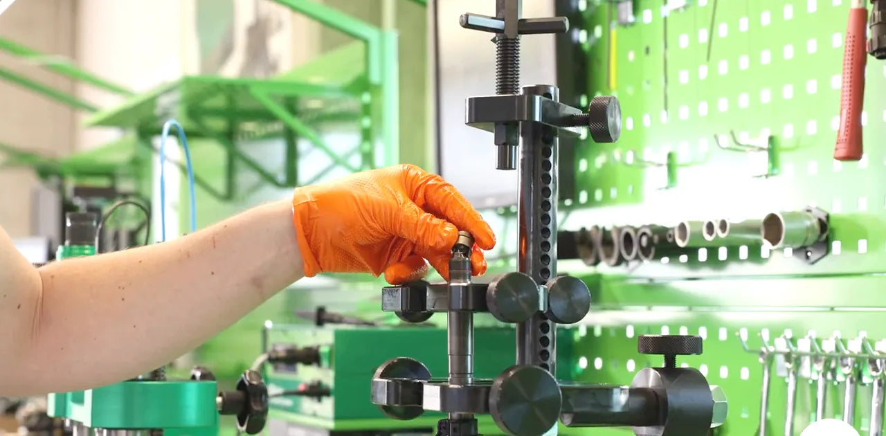 Technician inspecting an injector on the test bench