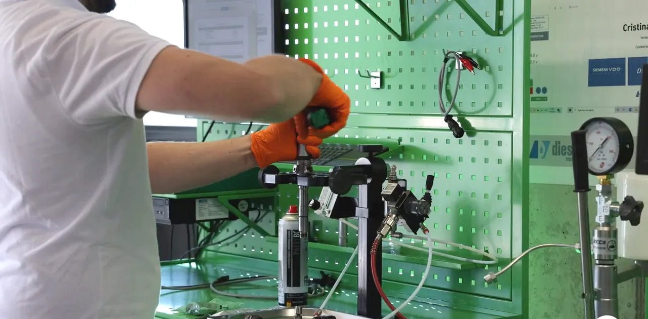 Diesel Solution technician working at the green Dieselland bench